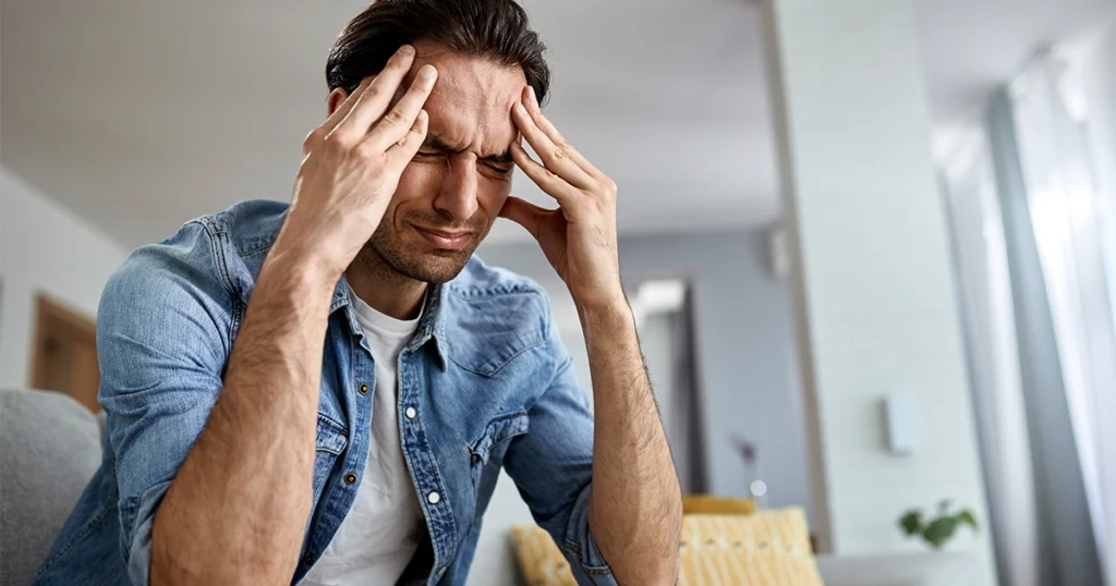 Man suffering from a painful headache.