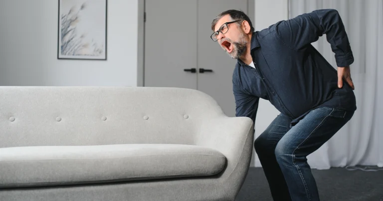 Improper lifting and strain causing lower back pain.