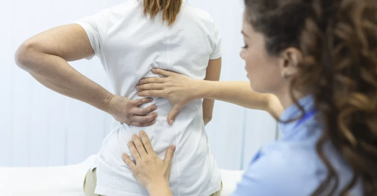 physiotherapist-doing-healing-treatment-womans-back-back-pain-patient-treatment-medical-doctor-massage