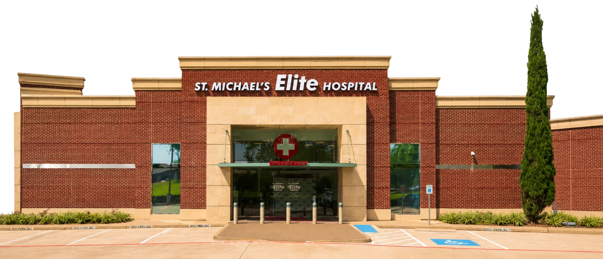 Front view of St. Michael’s Elite Hospital building with emergency entrance, red brick exterior, and accessible parking spaces.